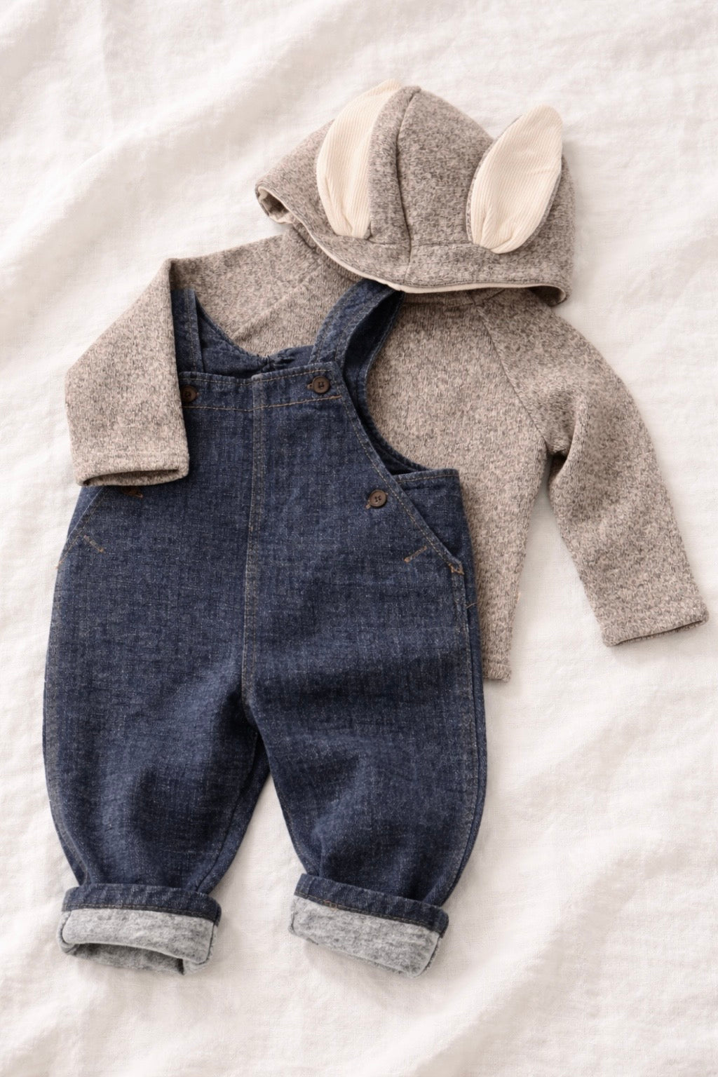 Children's denim overalls with a matching jacket on a light background